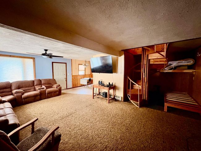 Living room to spiral staircase to upper level | Image 24