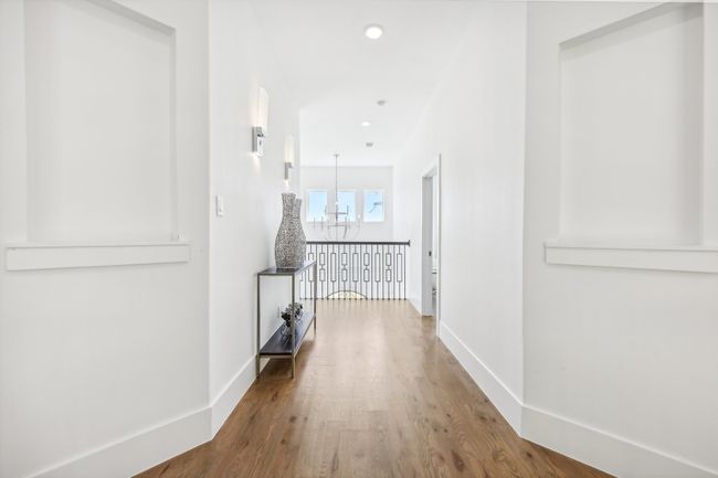 Corridor with a chandelier, wood finished floors, and recessed lighting | Image 31