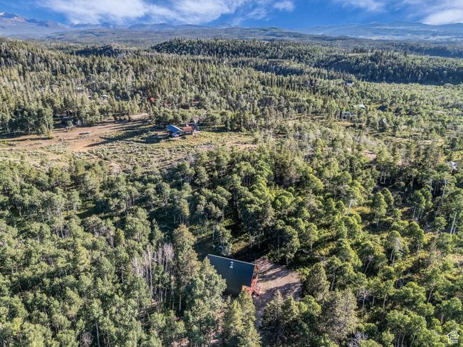 Aerial overview of property's location with a forest and mountains | Image 25