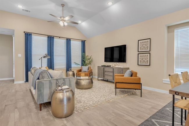 Living room with lofted ceiling, ceiling fan, light wood finished floors, and recessed lighting | Image 11