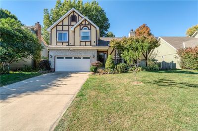 Tudor home featuring a garage and a front lawn | Image 2