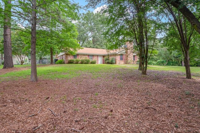 View of front of property with a chimney, a front yard, and brick siding | Image 37