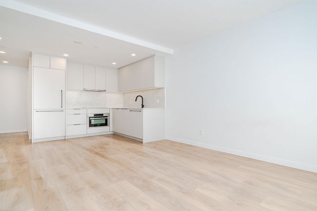 Unfurnished living room with baseboards, recessed lighting, light wood-type flooring, and a sink | Image 9