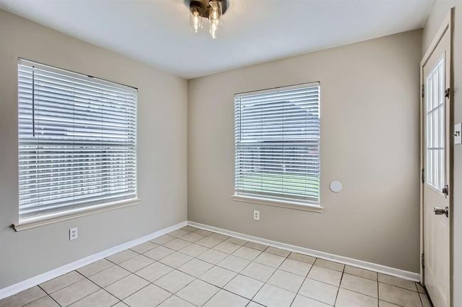 Breakfast Nook looking out to back yard with updated light fixture. | Image 19