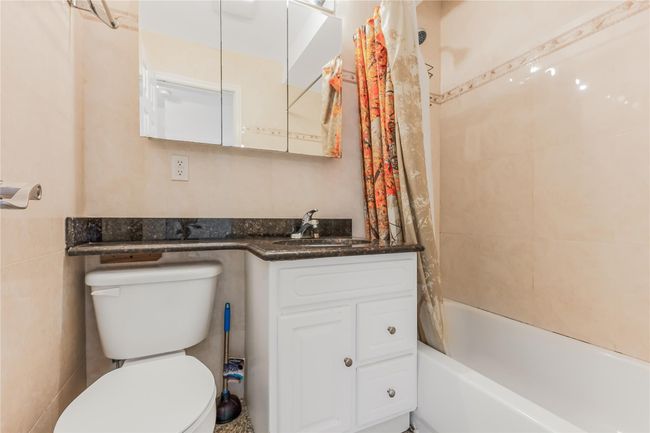 Full bathroom with vanity and shower / bath combo with shower curtain | Image 18