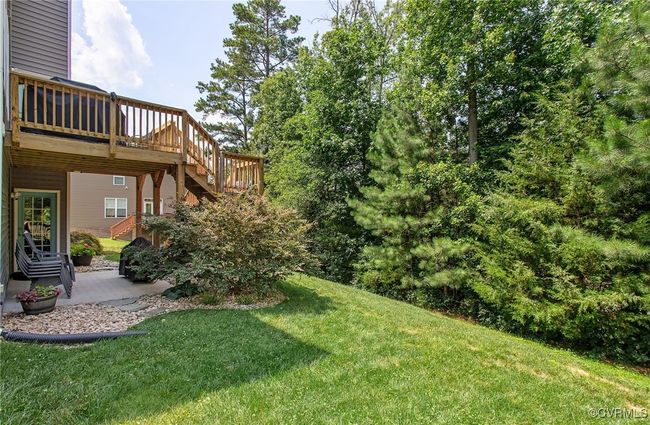Beautifully kept yard with natures privacy - concrete patio from walk out basement | Image 41