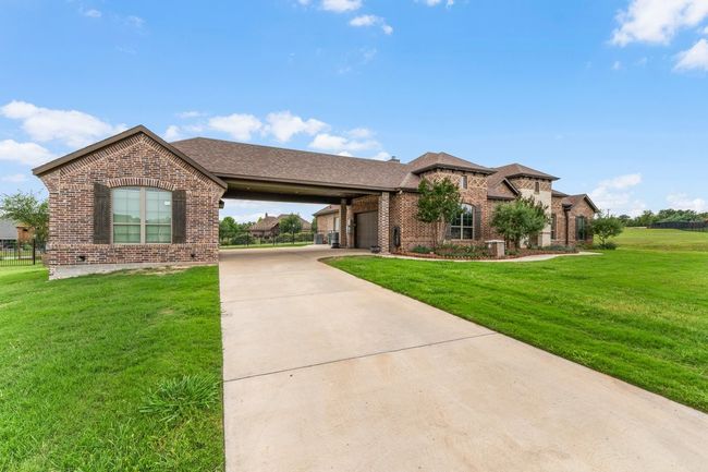 View of front of house featuring brick siding, concrete driveway, an attached garage, and a front yard | Image 34