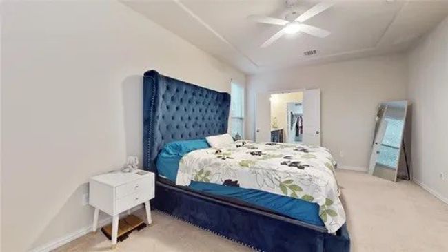 Bedroom with carpet flooring, a ceiling fan, and ensuite bath | Image 18