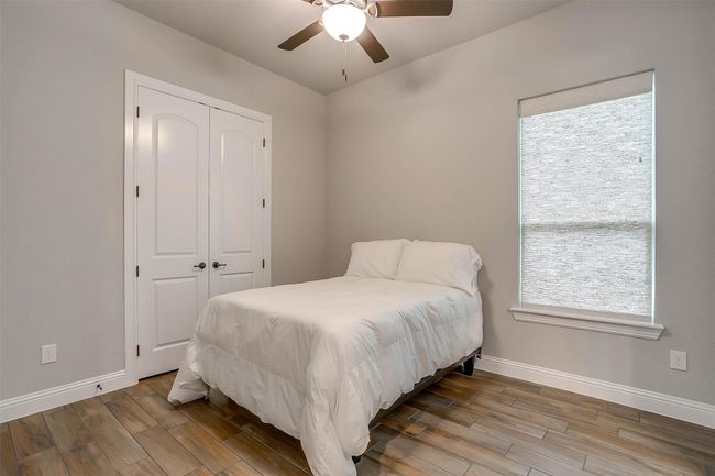 Bedroom with wood finished floors, a closet, and ceiling fan | Image 20