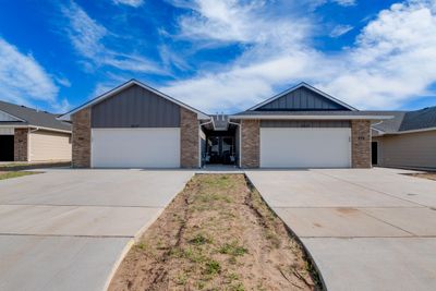 Ranch-style house featuring a garage | Image 2