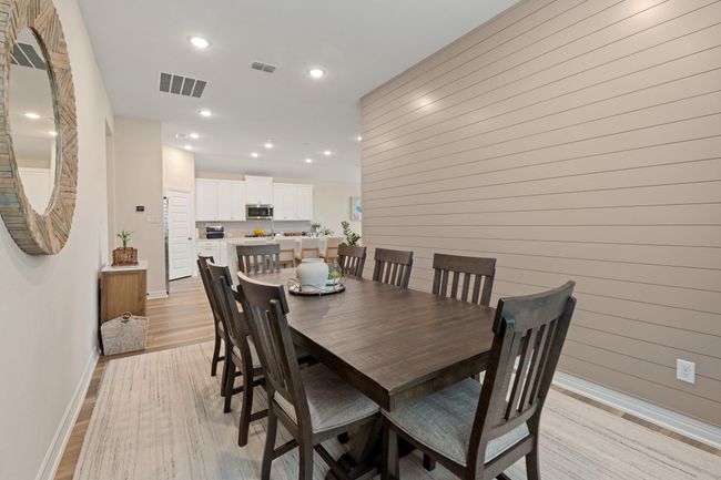 The dedicated dining room right off the kitchen has loads of natural light. The upgraded shiplap wall brings in an architectural element adding extra ambiance to you dining experience. | Image 10