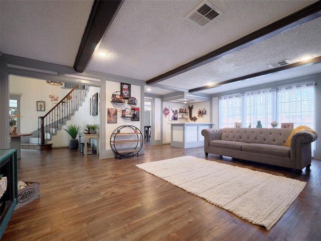 The spacious den offers a view of the pool and is filled with natural light. | Image 5