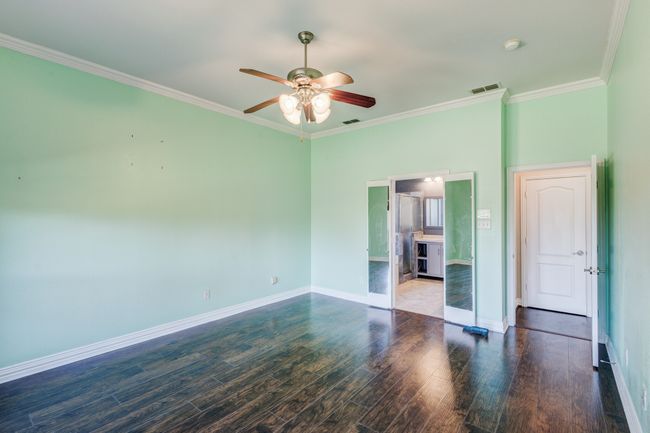 Spare room featuring ceiling fan, dark hardwood / wood-style floors, and crown molding | Image 13