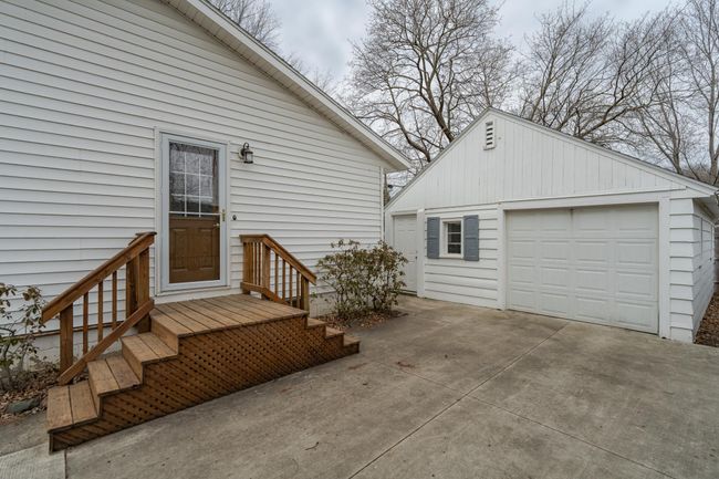 Side of the home showing the door into the kitchen area | Image 25