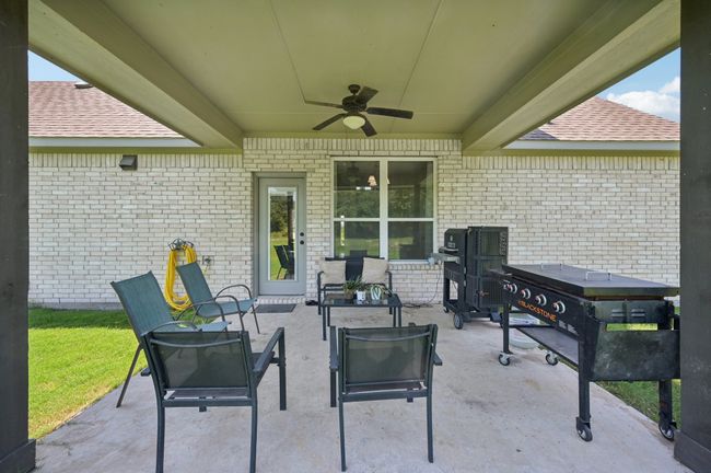 Back patio / terrace featuring ceiling fan | Image 19
