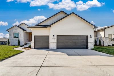 View of front of house featuring a garage and a front lawn | Image 1