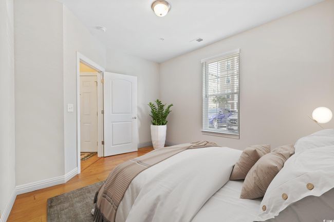 Bedroom featuring light wood-style floors and baseboards | Image 26