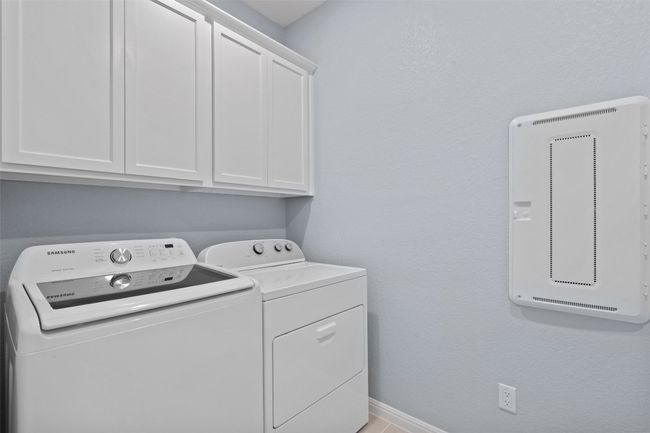 Laundry room featuring cabinet space, and separate washer and dryer. | Image 25