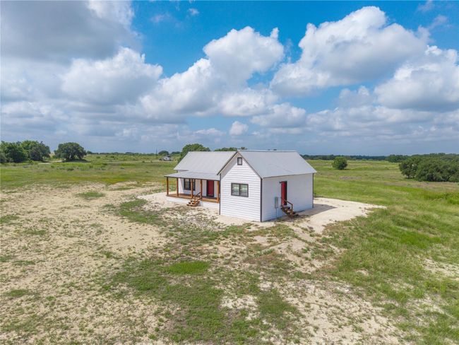 View of home's exterior featuring a view of rural / pastoral area and a metal roof | Image 5