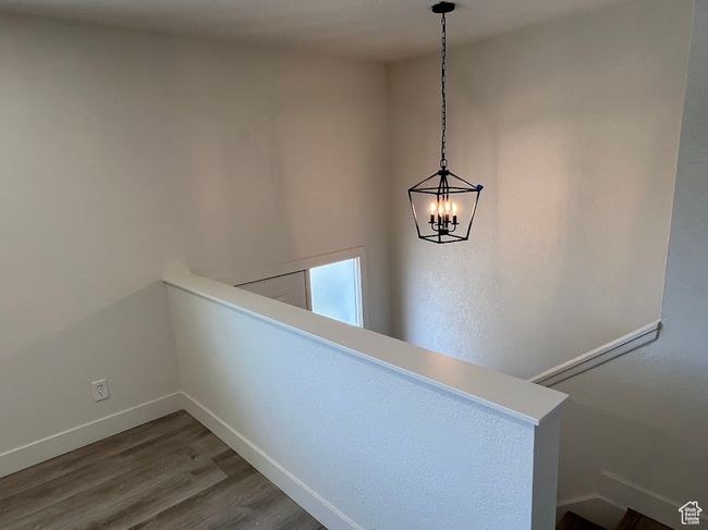 Detailed view of wood finished floors and a chandelier | Image 11