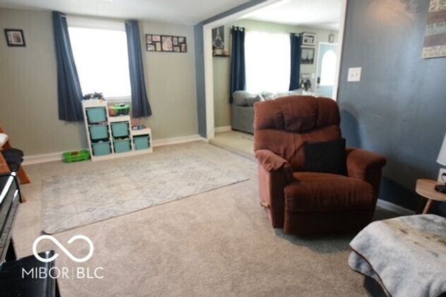 living area with baseboards and carpet flooring | Image 9