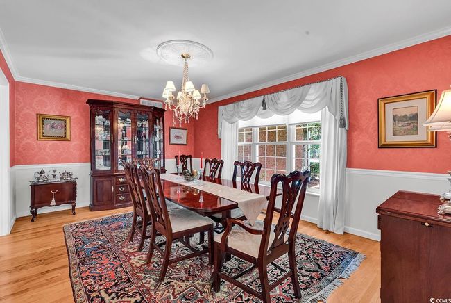 Dining room featuring a chandelier, light wood-style floors, and ornamental molding | Image 6
