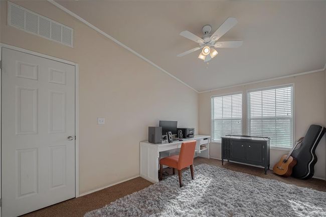 Another bedroom that is well-lit with a ceiling fan that adds to the ambiance. | Image 26