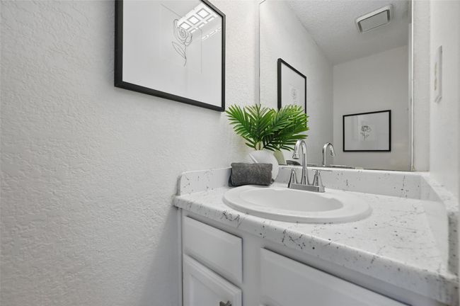 Bathroom with visible vents, vanity, a textured wall, and a textured ceiling | Image 7