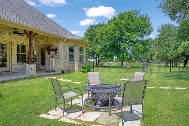 View of yard featuring ceiling fan and a patio | Image 18
