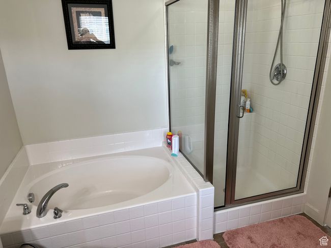 Bathroom with a stall shower and a bath | Image 25
