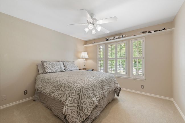 Bright and cozy secondary bedroom featuring plantation shutters | Image 24