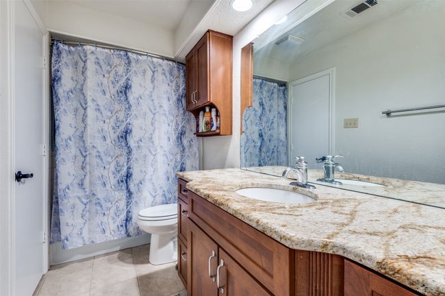 Full bath featuring vanity, tile patterned flooring, and toilet | Image 9
