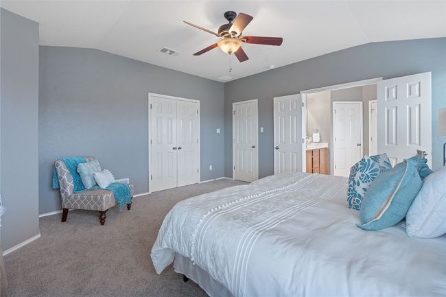 Bedroom with vaulted ceiling, carpet floors, ceiling fan, and a closet | Image 27