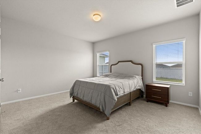Bedroom with light carpet and baseboards | Image 16