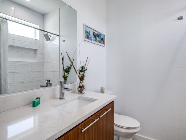 Full bath featuring curtained shower and vanity | Image 18