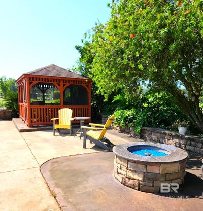 View of patio / terrace featuring a gazebo and an outdoor fire pit | Image 2