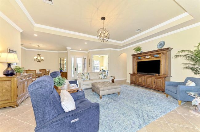 Great Room with Tray Ceiling and Crown Molding w/Tile Floors | Image 19