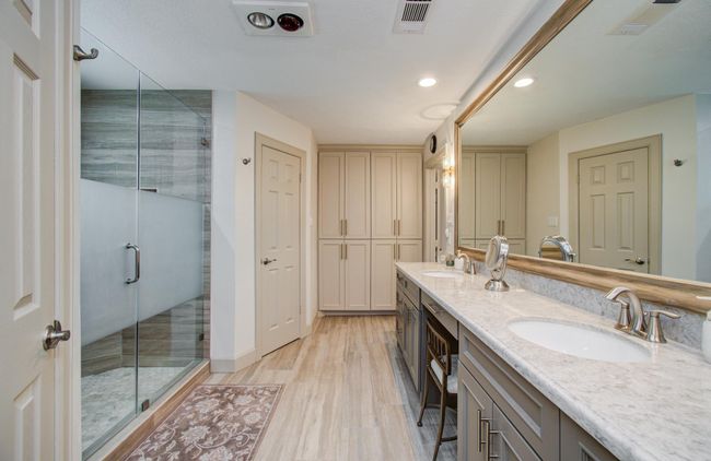 Expansive countertop with dual sinks and amazingly large mirror . And look at all of the storage cabines with soft close doors! | Image 25