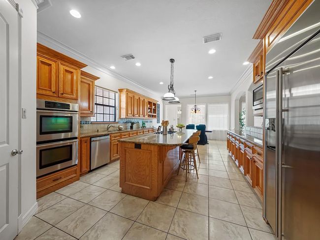 Spacious kitchen featuring a huge island with a brand new gas cooktop. | Image 21
