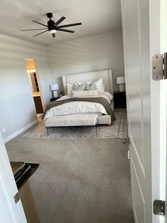 Carpeted master bedroom with a ceiling fan | Image 29