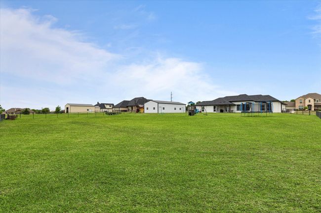 View of yard featuring fence and a residential view | Image 37