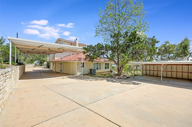 Detached, oversized Carport, perfect for an RV, and the expansive driveway. Let's go inside and take a tour. | Image 4