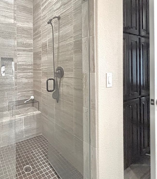 Full bath with a stall shower and a textured wall | Image 24