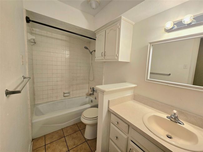 Bathroom with tile patterned flooring, vanity, and bathing tub / shower combination | Image 20