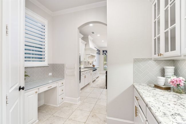 Kitchen features additional butler's station, desk, dry bar and walk in pantry for loads of storage and walk through to the formal dining space. | Image 15