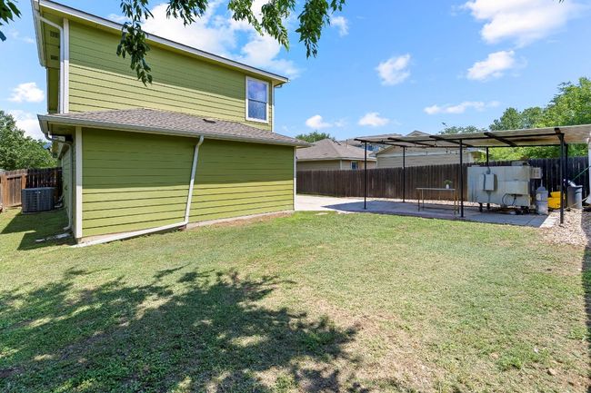 Fenced backyard with a patio area | Image 40