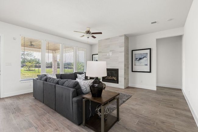 Living area with ceiling fan, baseboards, and healthy amount of natural light | Image 17