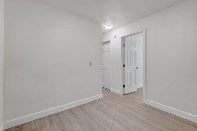 Empty room with light wood-style flooring and baseboards | Image 21