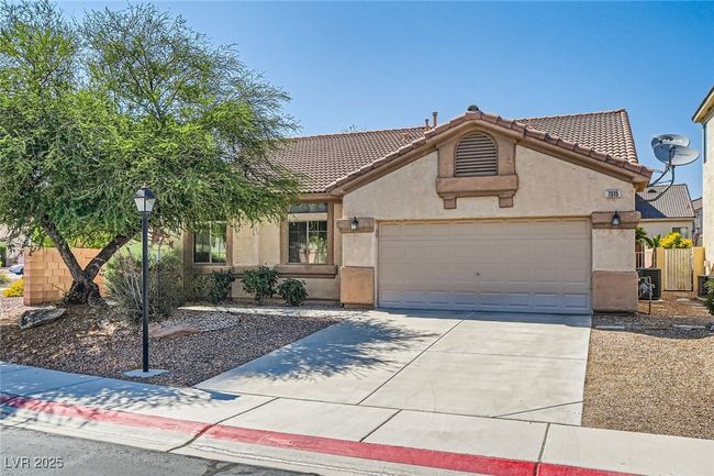 View of front of property with stucco siding, an attached garage, driveway, and a tiled roof | Image 5