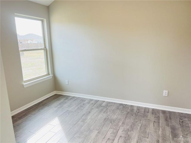 Spare room with a mountain view and light wood-type flooring | Image 9
